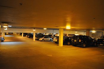 A parking garage full of cars at night